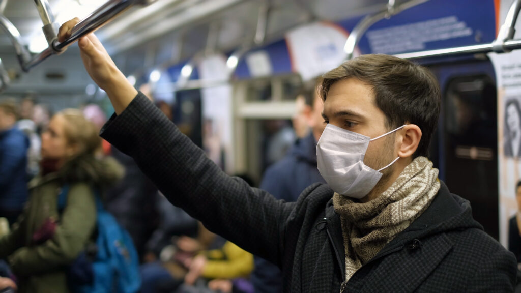 COVID-19 – a commuter ewaring a mask (photo from Getty)