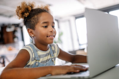 Girl spending time with notebook and modern technology