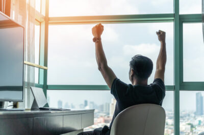 Business achievement Man with his arms up in celebration