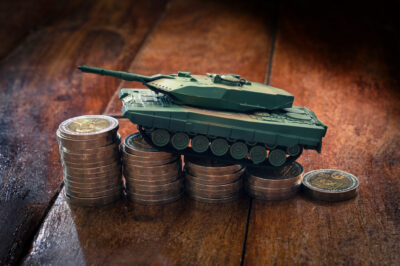 Small plastic tank on money coins.