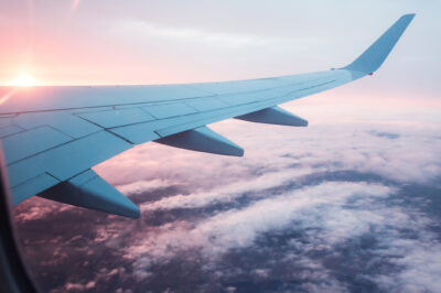 View from porthole of an airplane of the sunset.